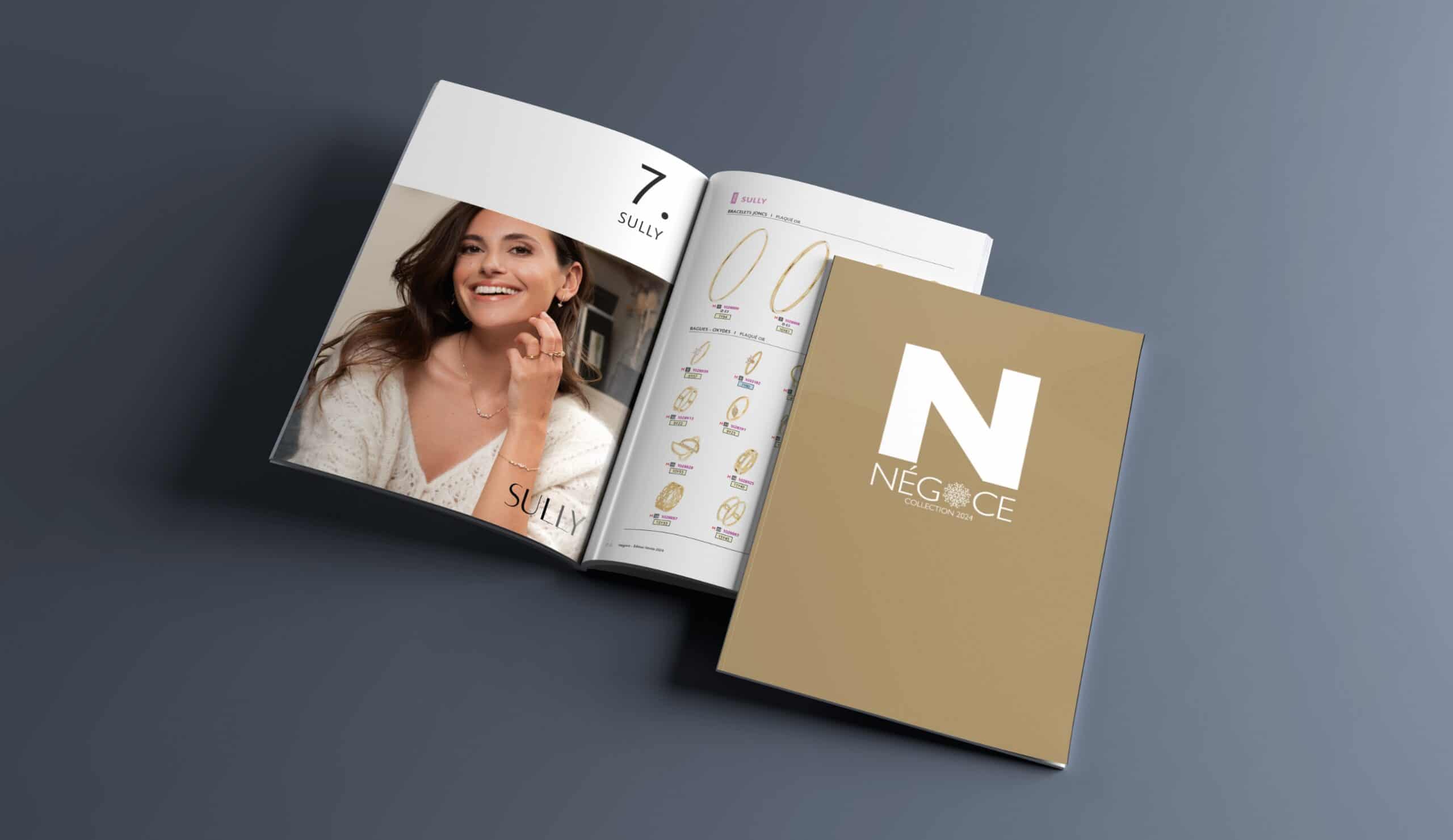 NÉGOCE jewellery catalogue open on a page featuring gold rings and a model wearing matching accessories.