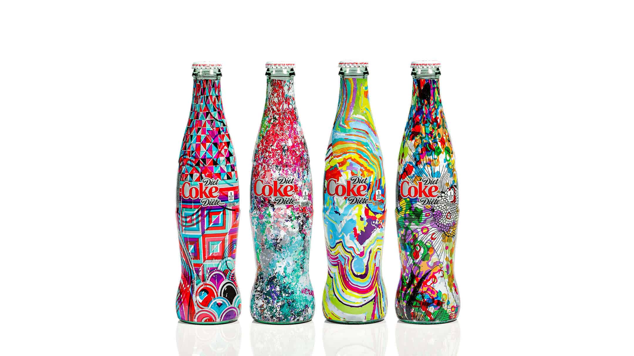 Four Diet Coke glass bottles with unique and colorful artistic designs against a white background