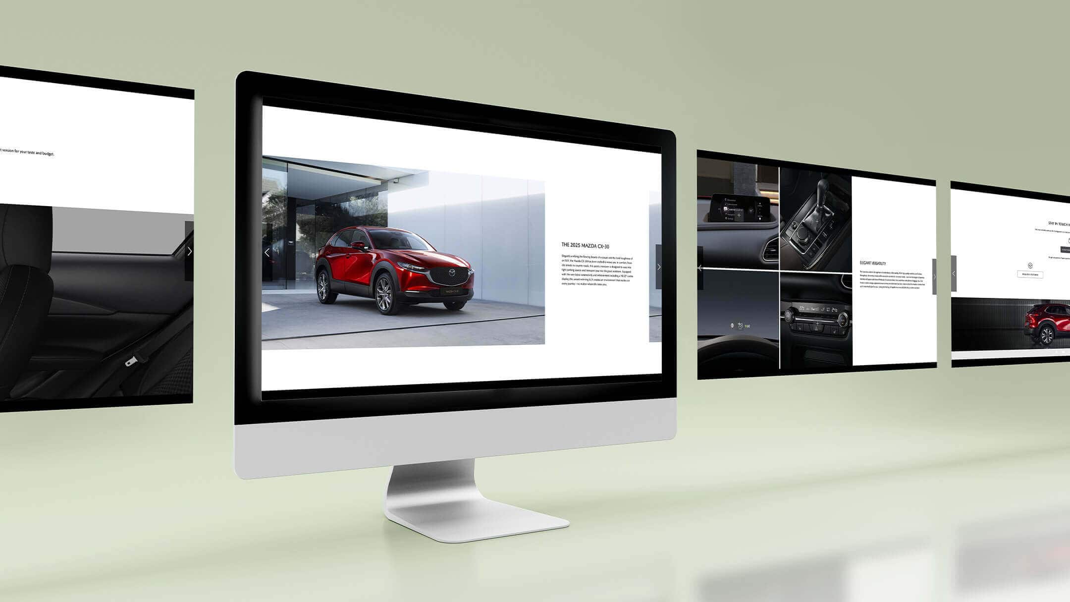 Computer screens showcasing the digital brochure of the Mazda CX-30, with exterior and interior visuals