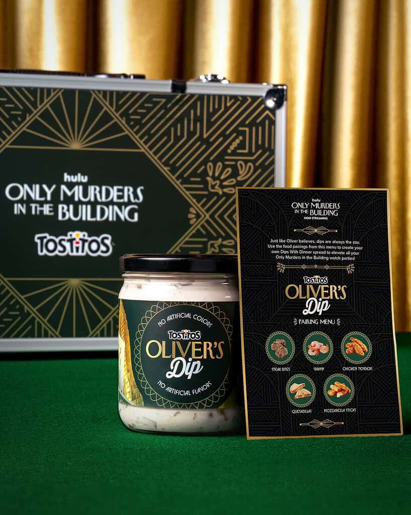 Hulu Only Murders in the Building promotional display with Tostitos Olive's Dip jar and informational card.